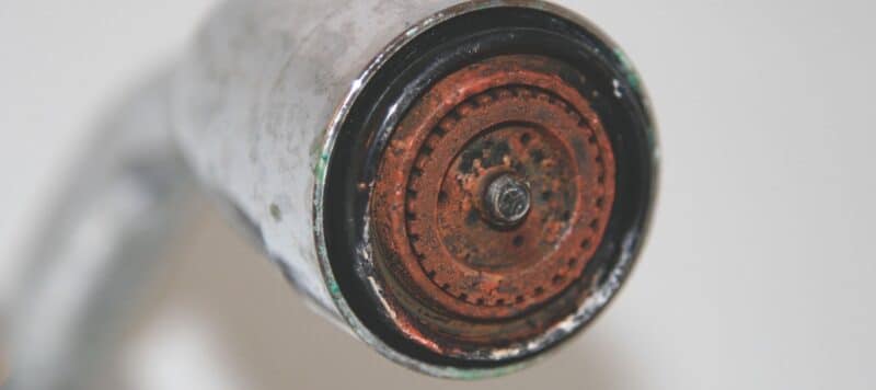 closeup of a very rusted over shower head