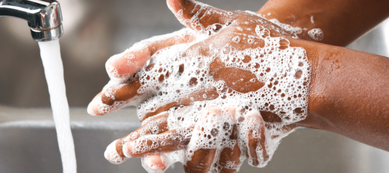 closeup of hands being washed with soap