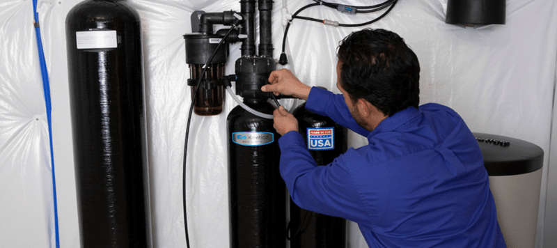 kinetico tech working on a kinetico brand water softener