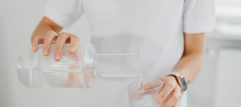 Pouring water from a glass pitcher